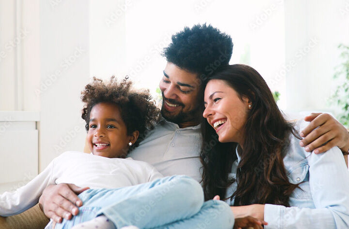 Parents and children embracing at home