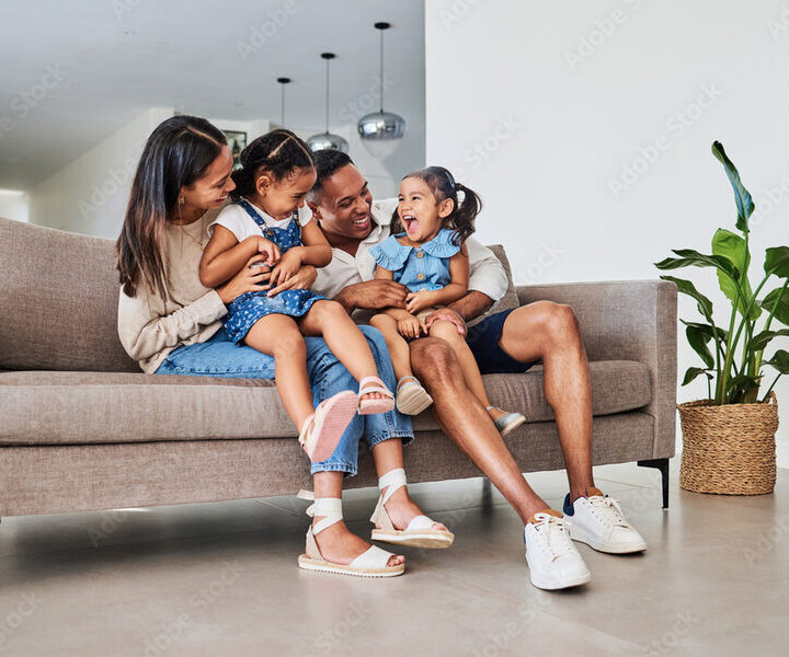 Sisters embracing on the couch at home