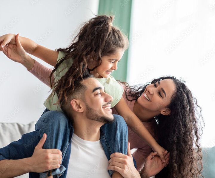 Parents playing with their child at home